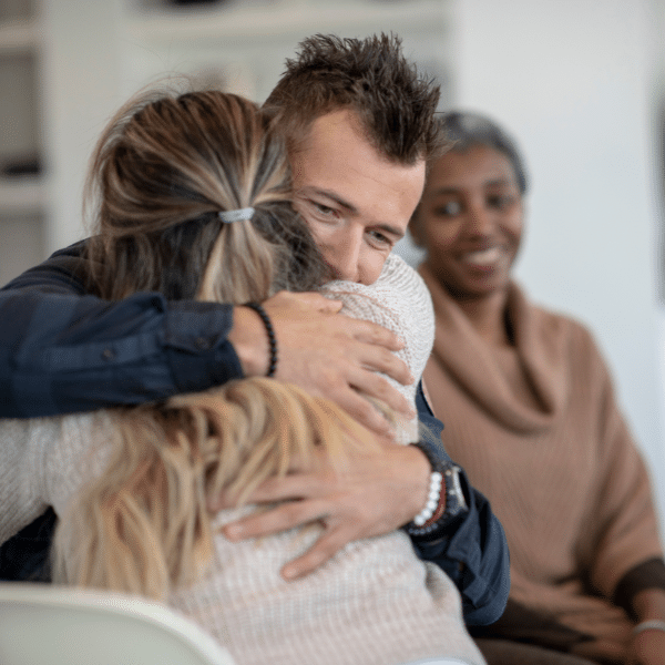 Supportive family helping a loved one through outpatient addiction treatment.
