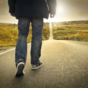 A person facing a fork in the road, ready to begin recovery