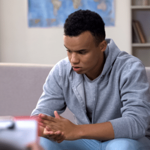 Man with head in hands dealing with inner struggle